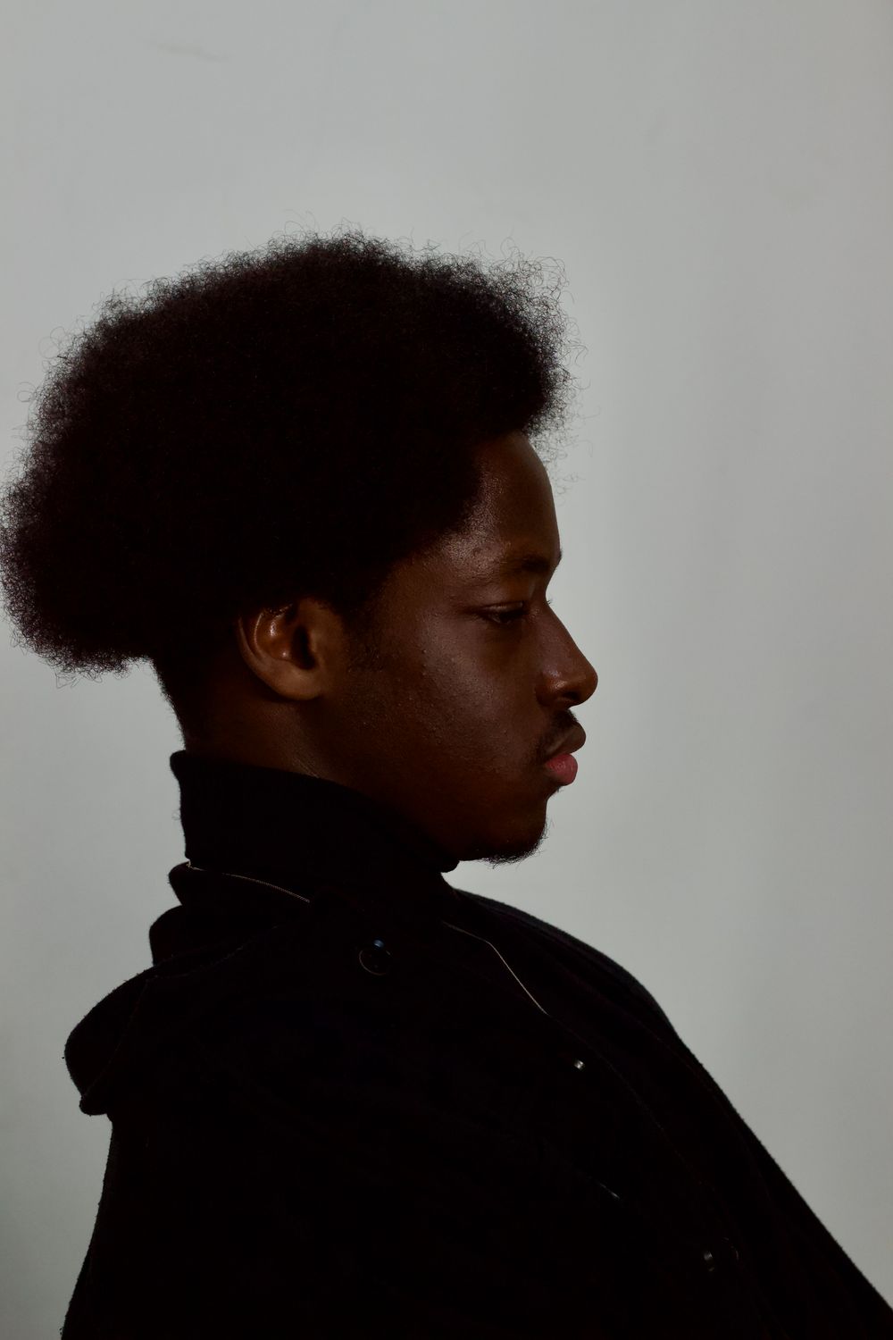 side profile of young man with natural afro hair