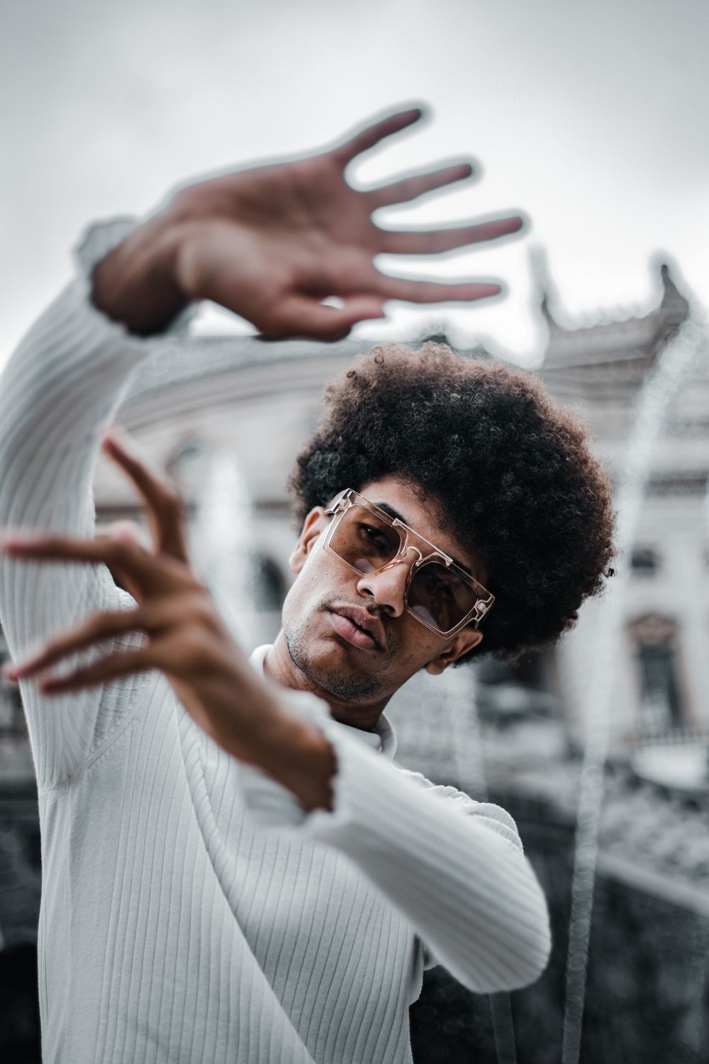 man with short rounded afro hairstyle and glasses