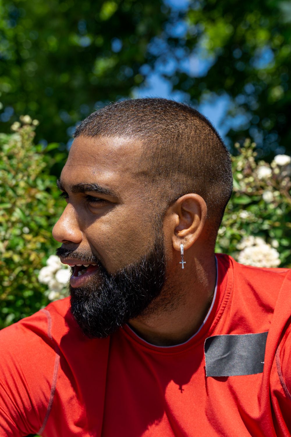 side profile of bearded man with short cropped hair