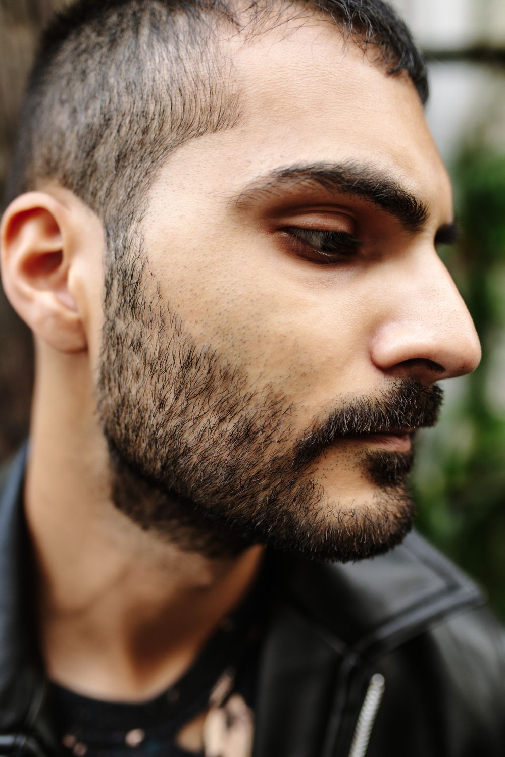young bearded man with short temple taper haircut