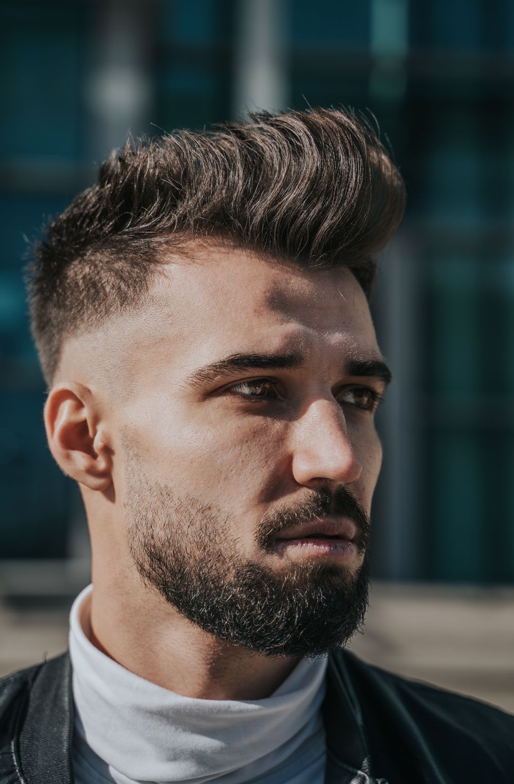 man with voluminous medium top hairstyle and beard