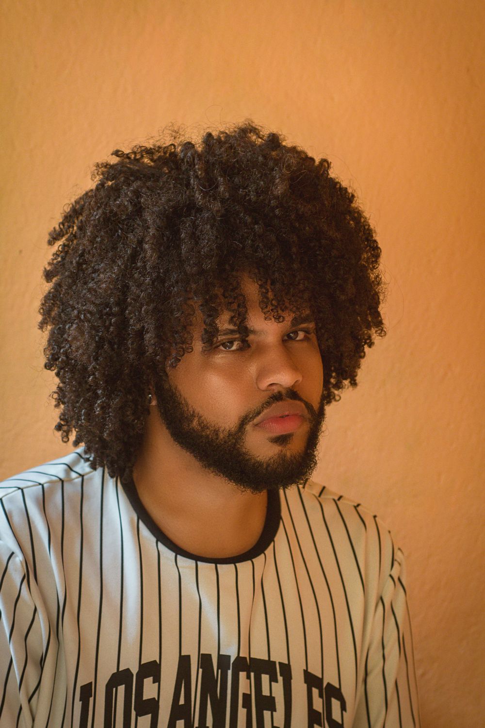 man with rounded afro hairstyle and beard