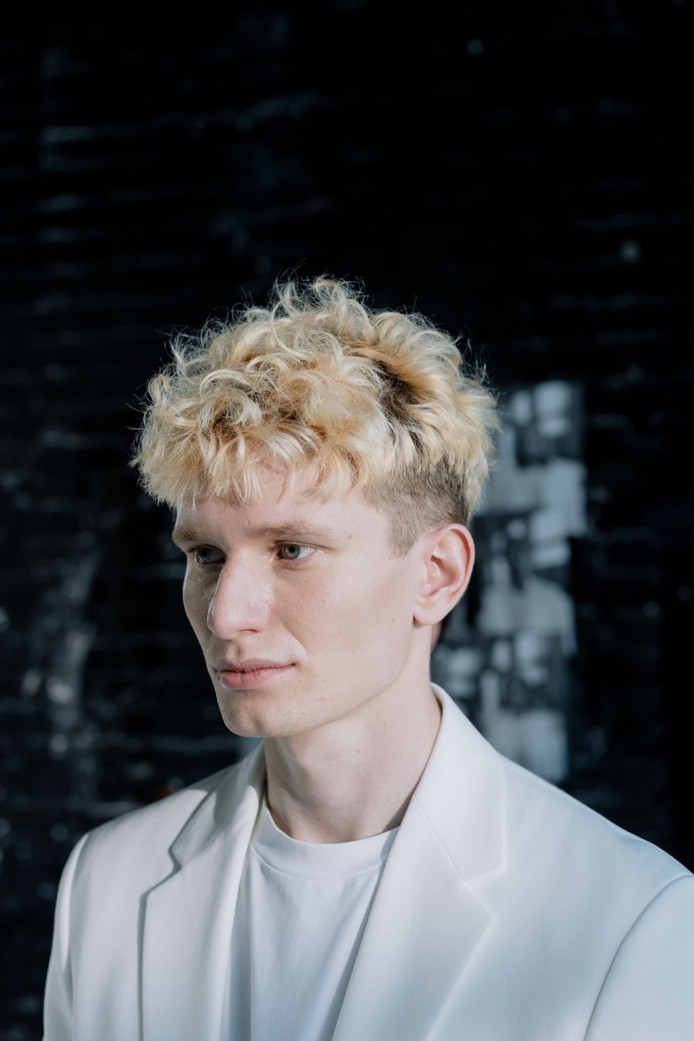 man with medium blonde wavy hair and soft volume