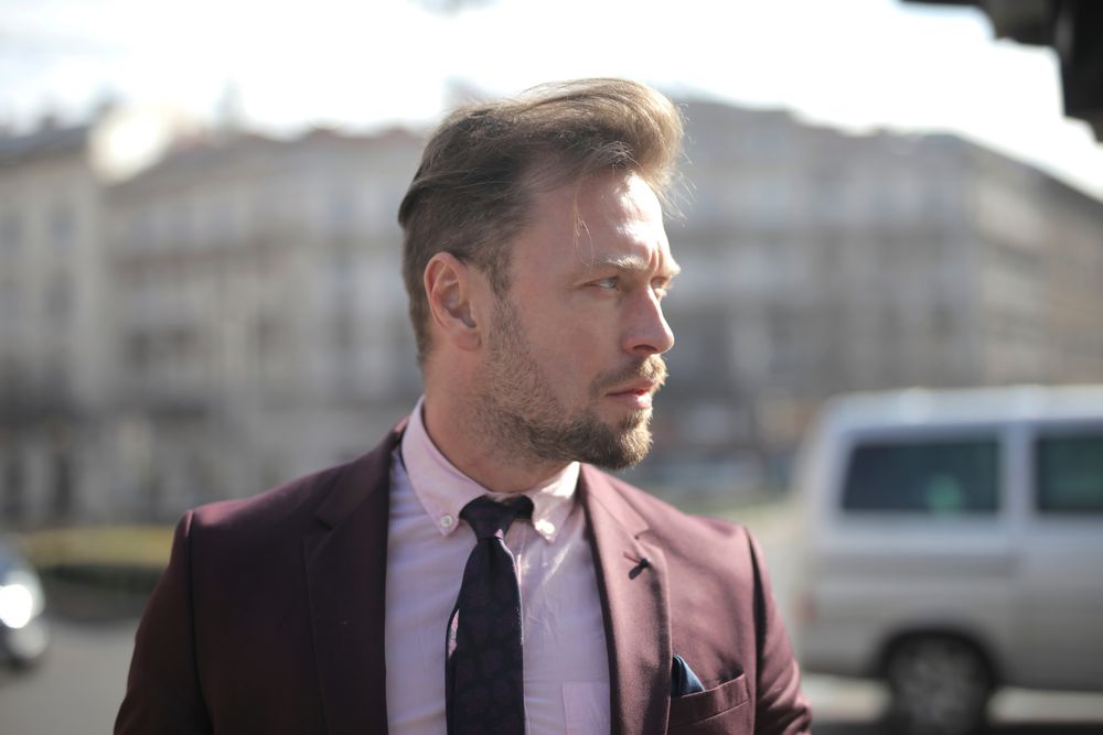 side profile of man with a relaxed side swept hairstyle and receding temples