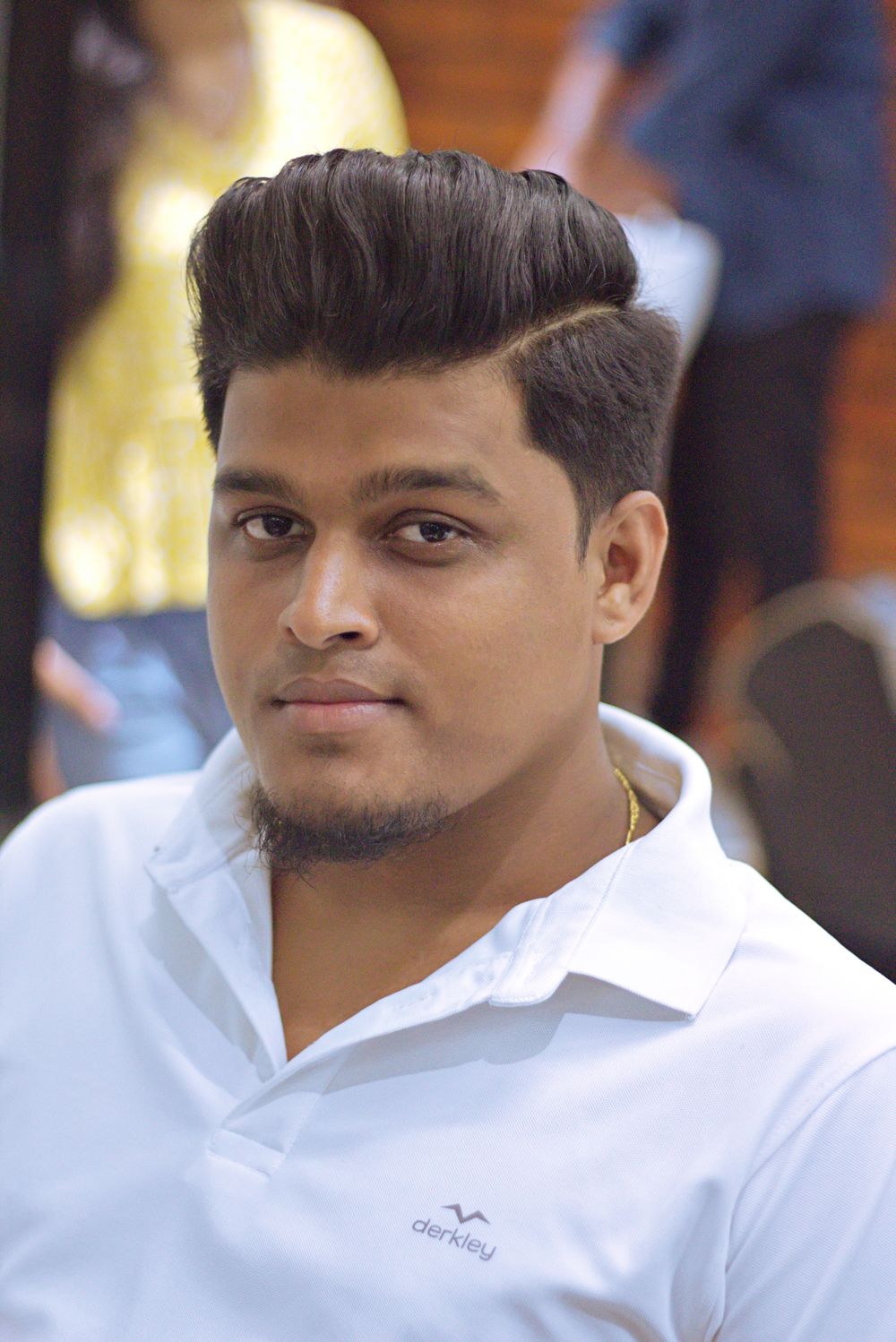 man with clean side part hairstyle and lifted front