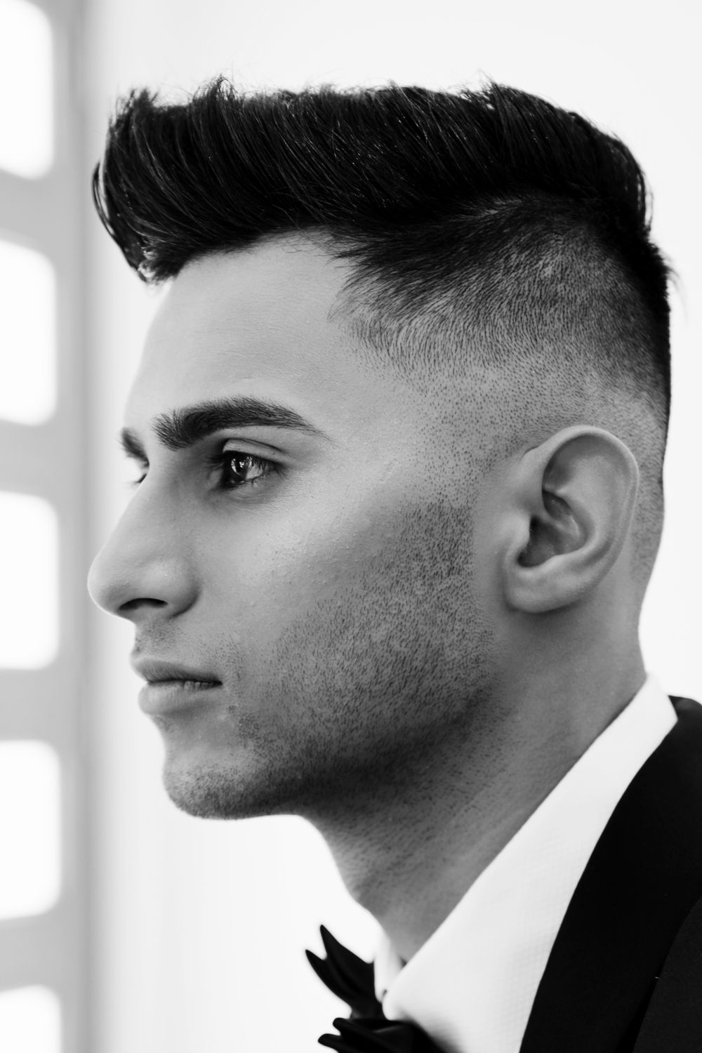 side profile of clean shaven man with a defined taper fade