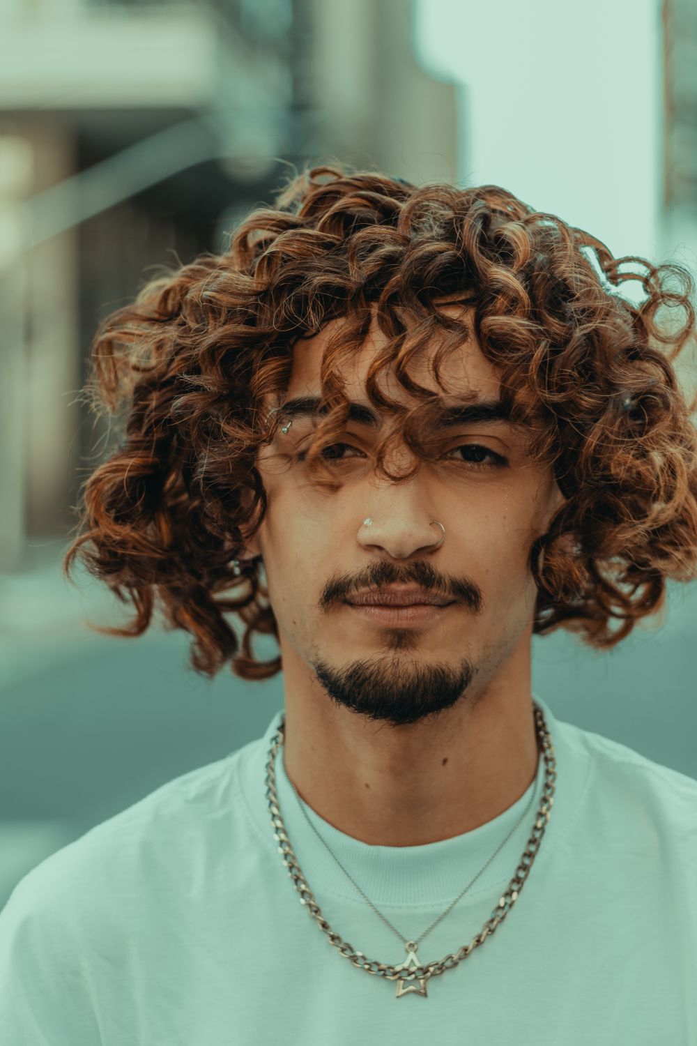 man with copper curly fringe and medium hairstyle