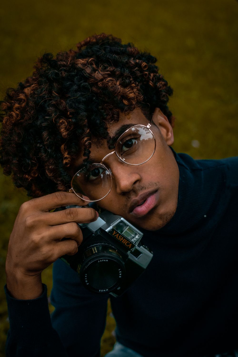 man with short curly crop hairstyle and glasses