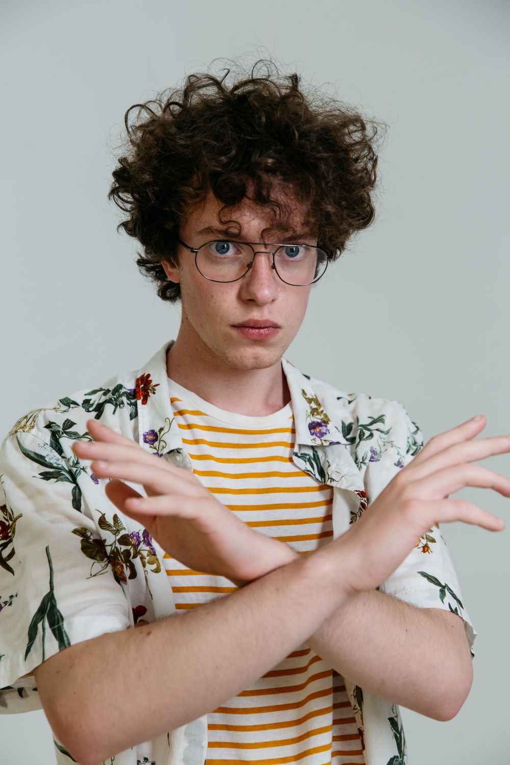 man with medium curly hair wearing glasses