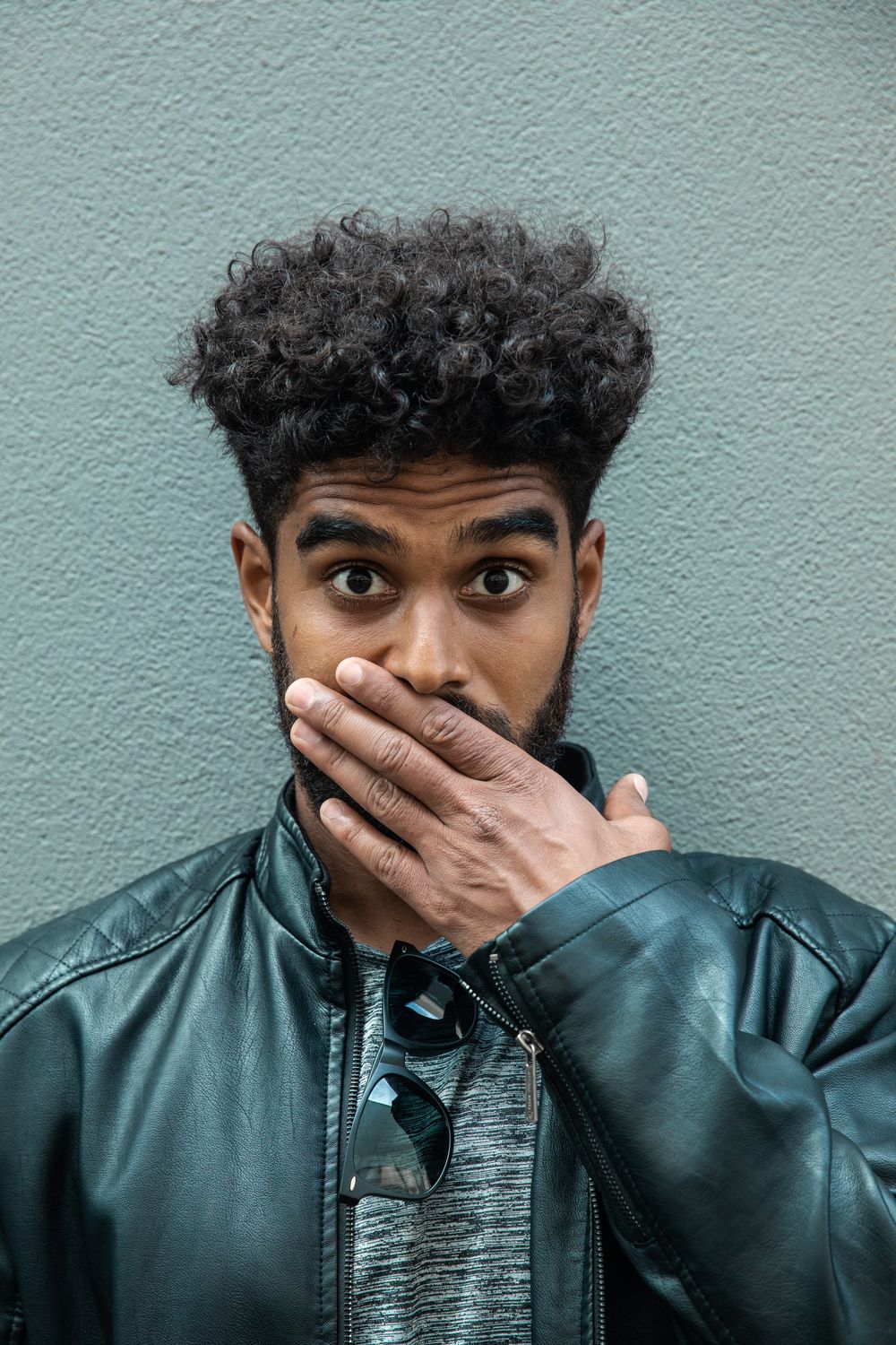 man with short curly high top hairstyle