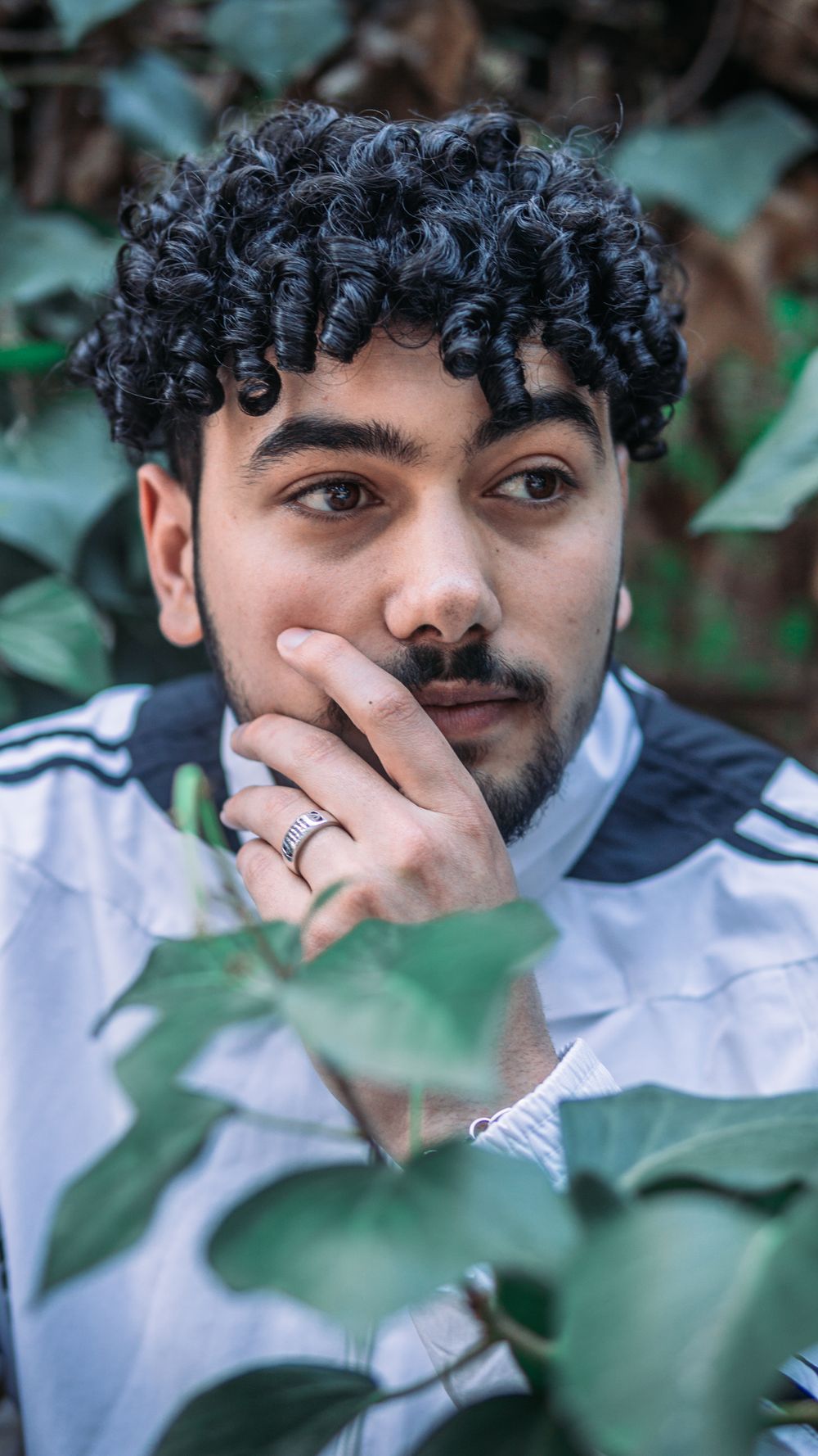 man with medium curly hair and natural volume outdoors