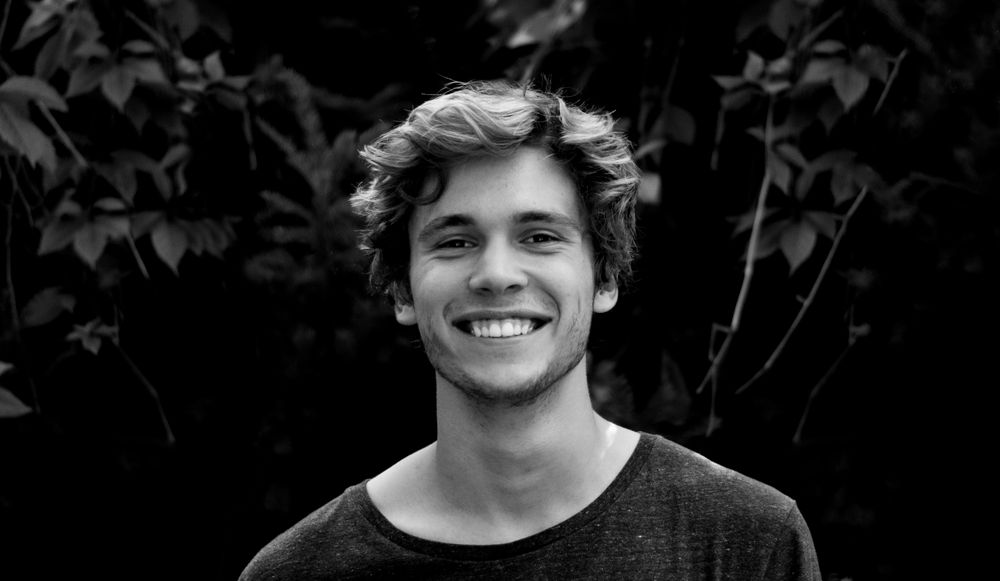 man with curly hair and close faded sides