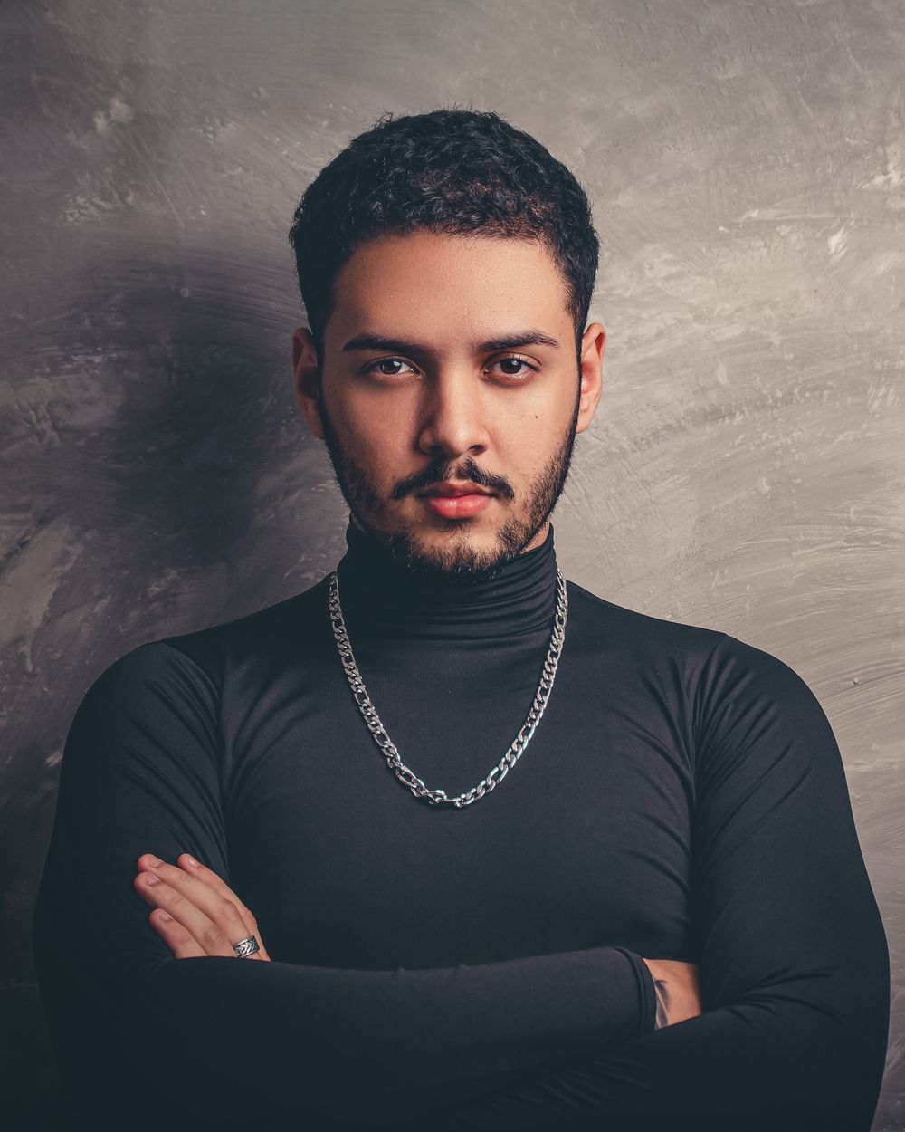 man with short curly hair and a clean tapered outline