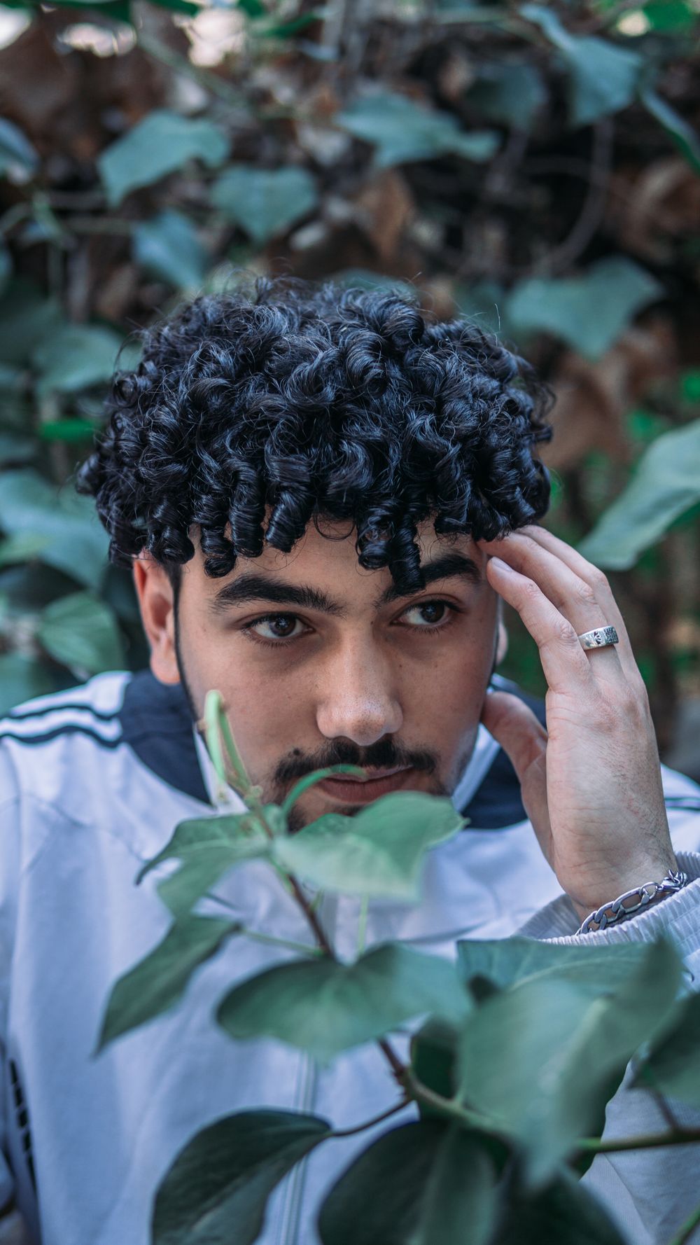 man with defined curly fringe and textured medium top