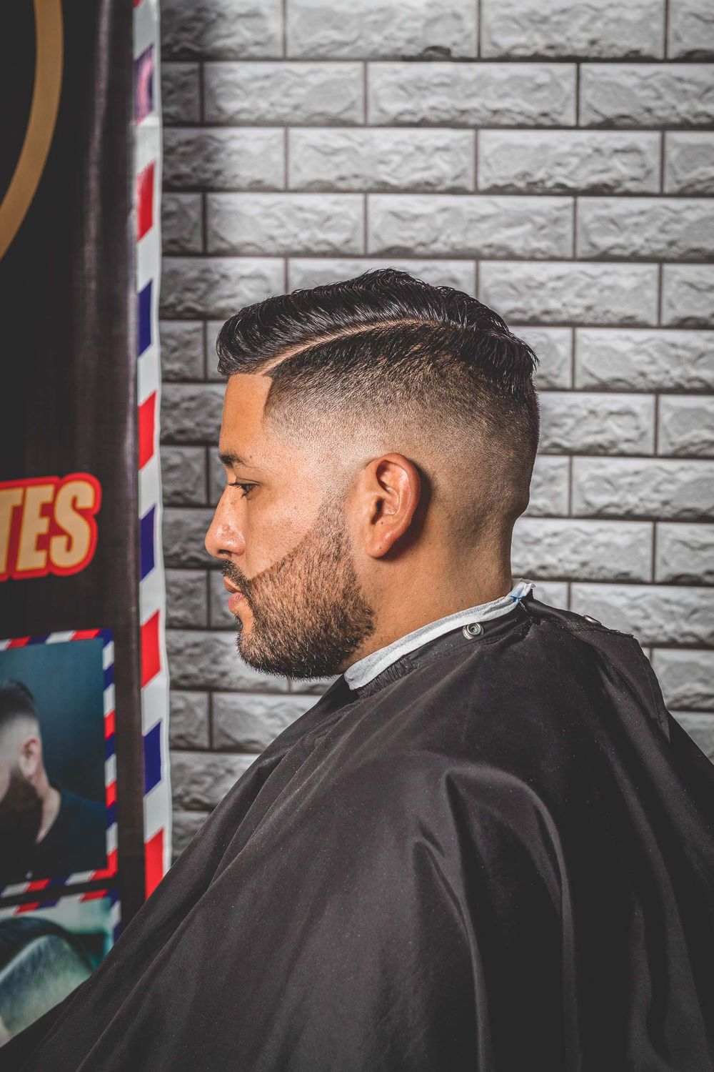 side profile of man with short defined taper fade