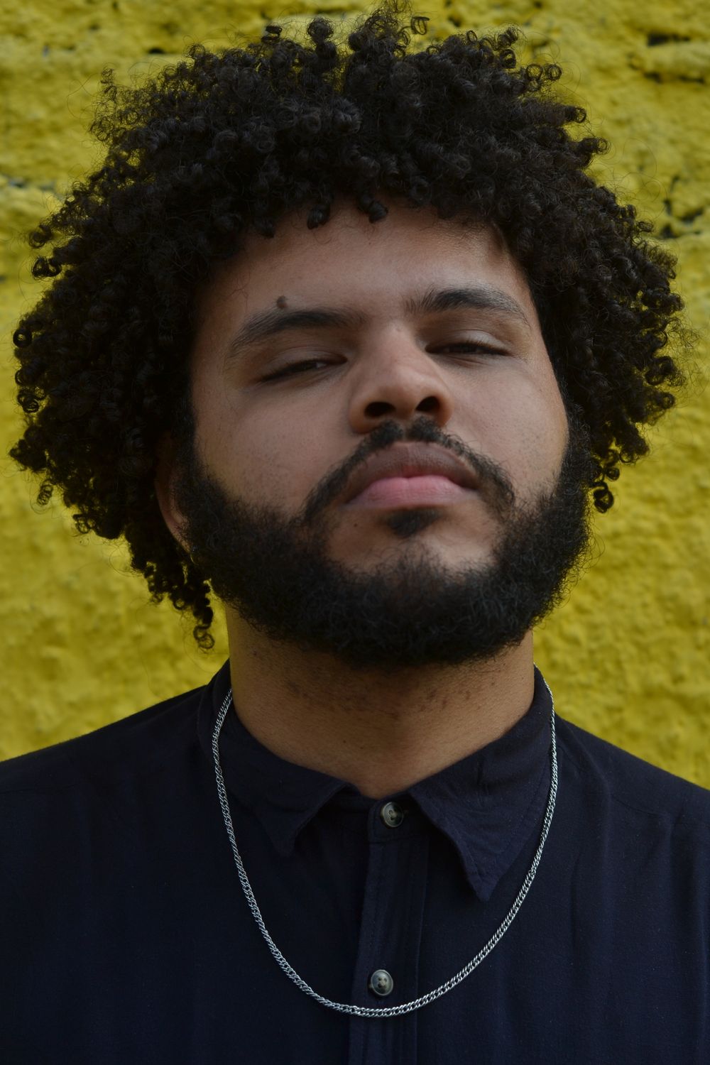 man with dense rounded curly hairstyle