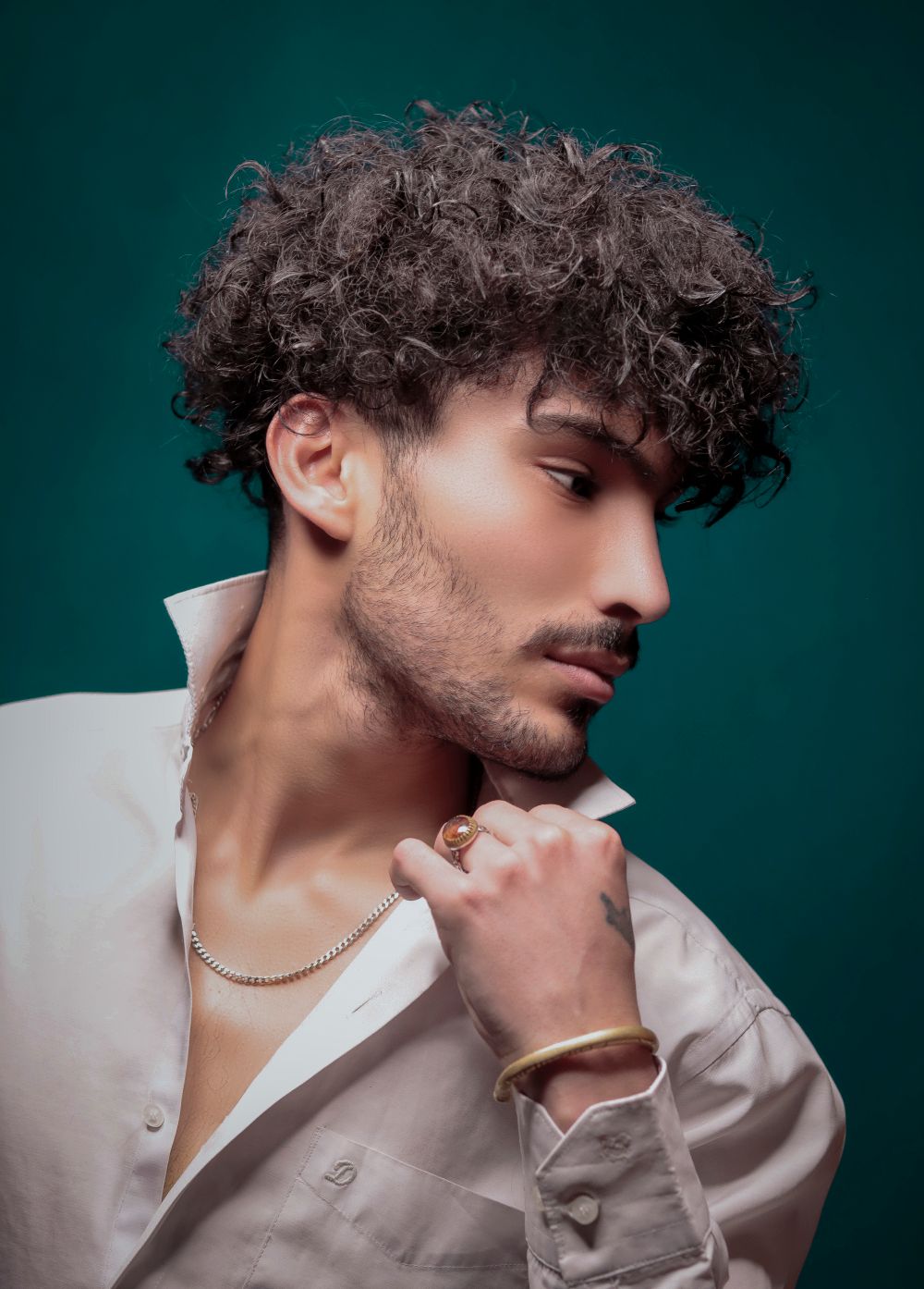 man with tousled curly hairstyle and soft volume