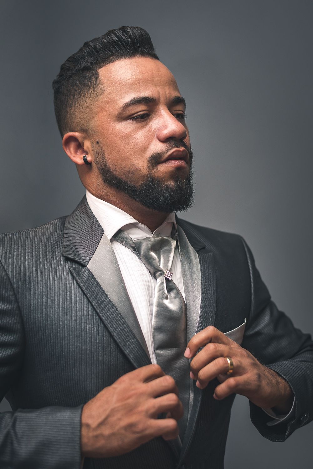 bearded man in a suit with a tidy short tapered haircut