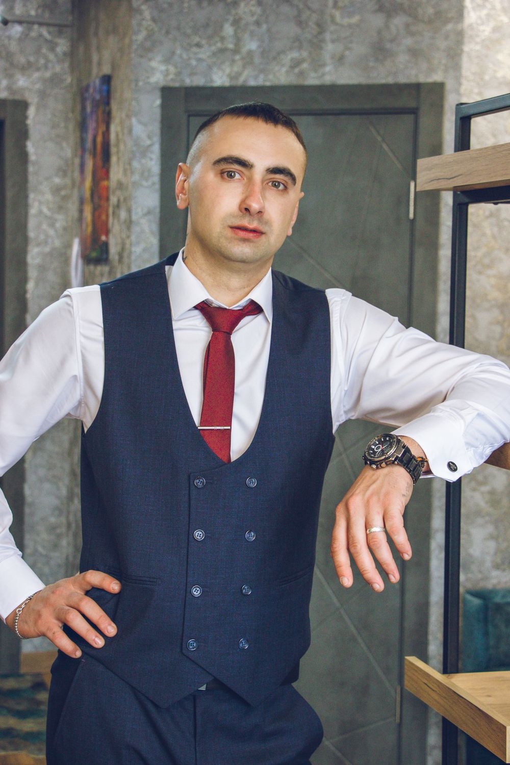 man in formal vest with a short tidy side part hairstyle
