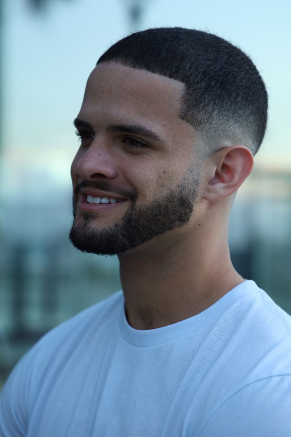 man with a short fresh taper fade and neatly trimmed beard