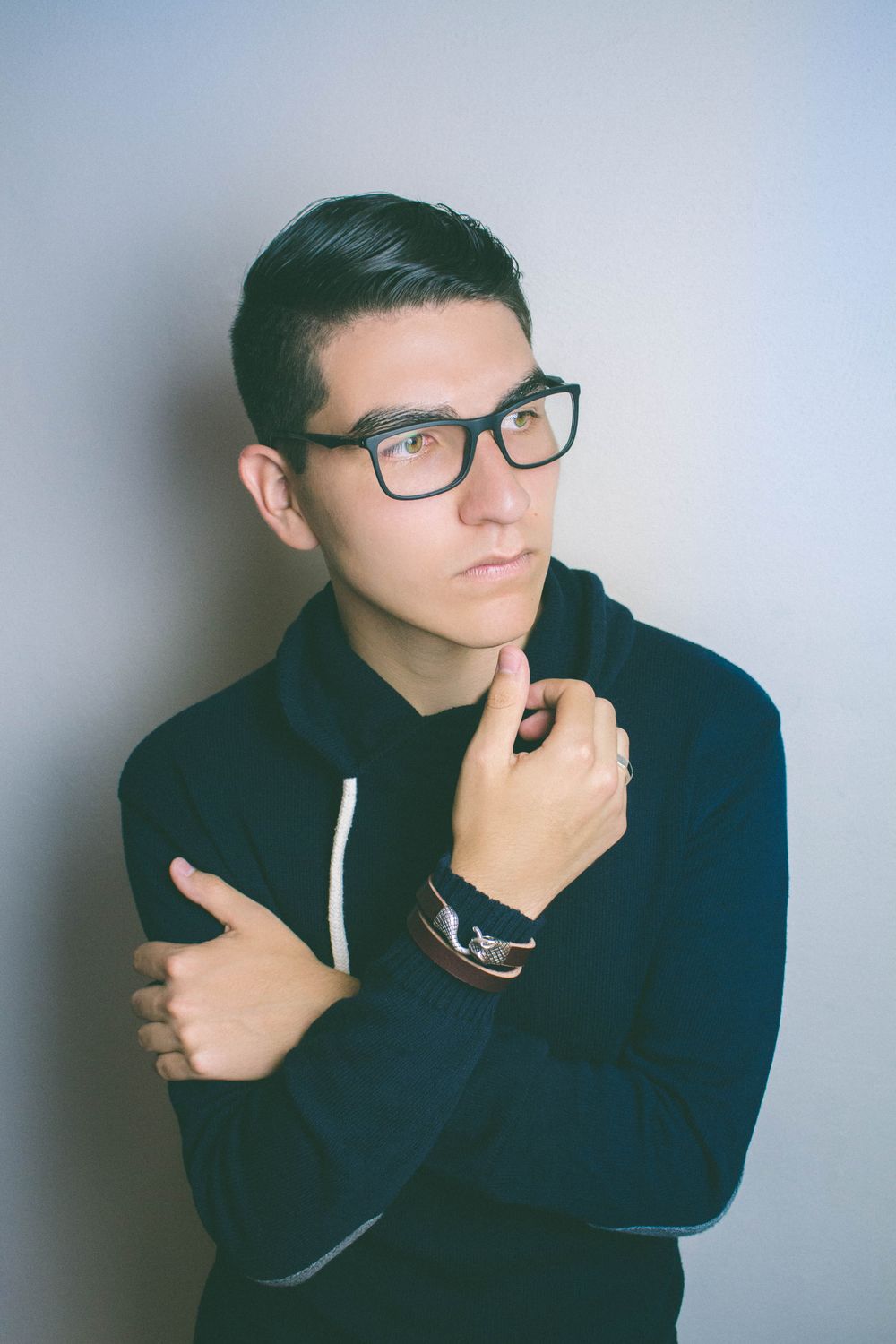 man wearing glasses with a clean short side part hairstyle