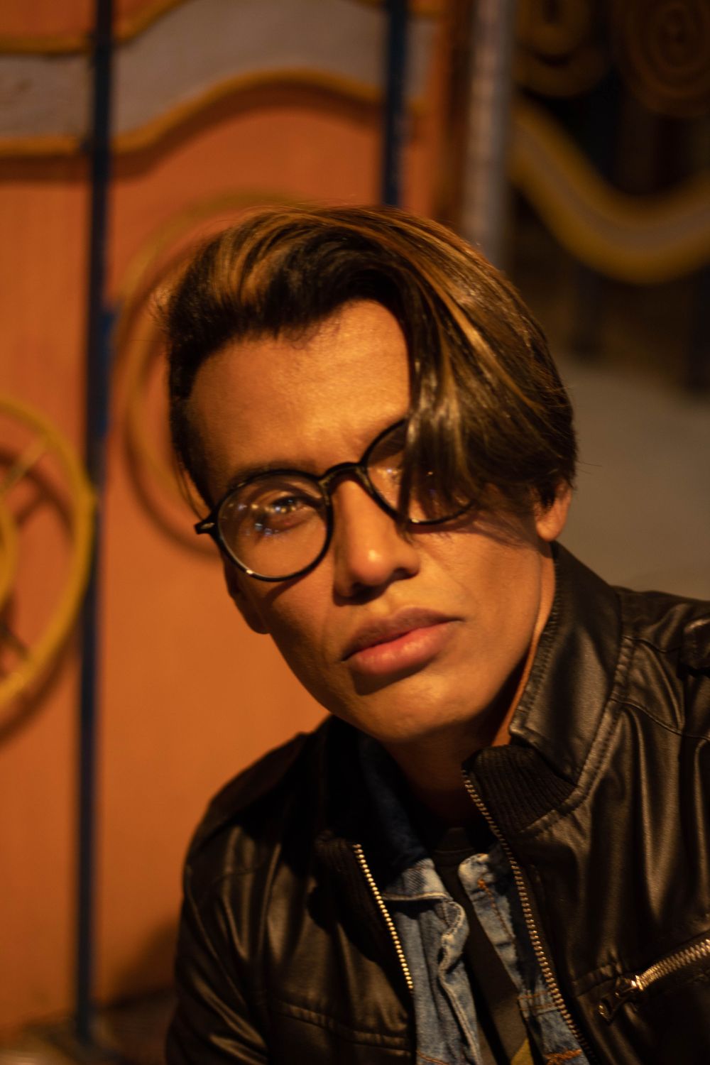 man wearing glasses with medium curtain style hair