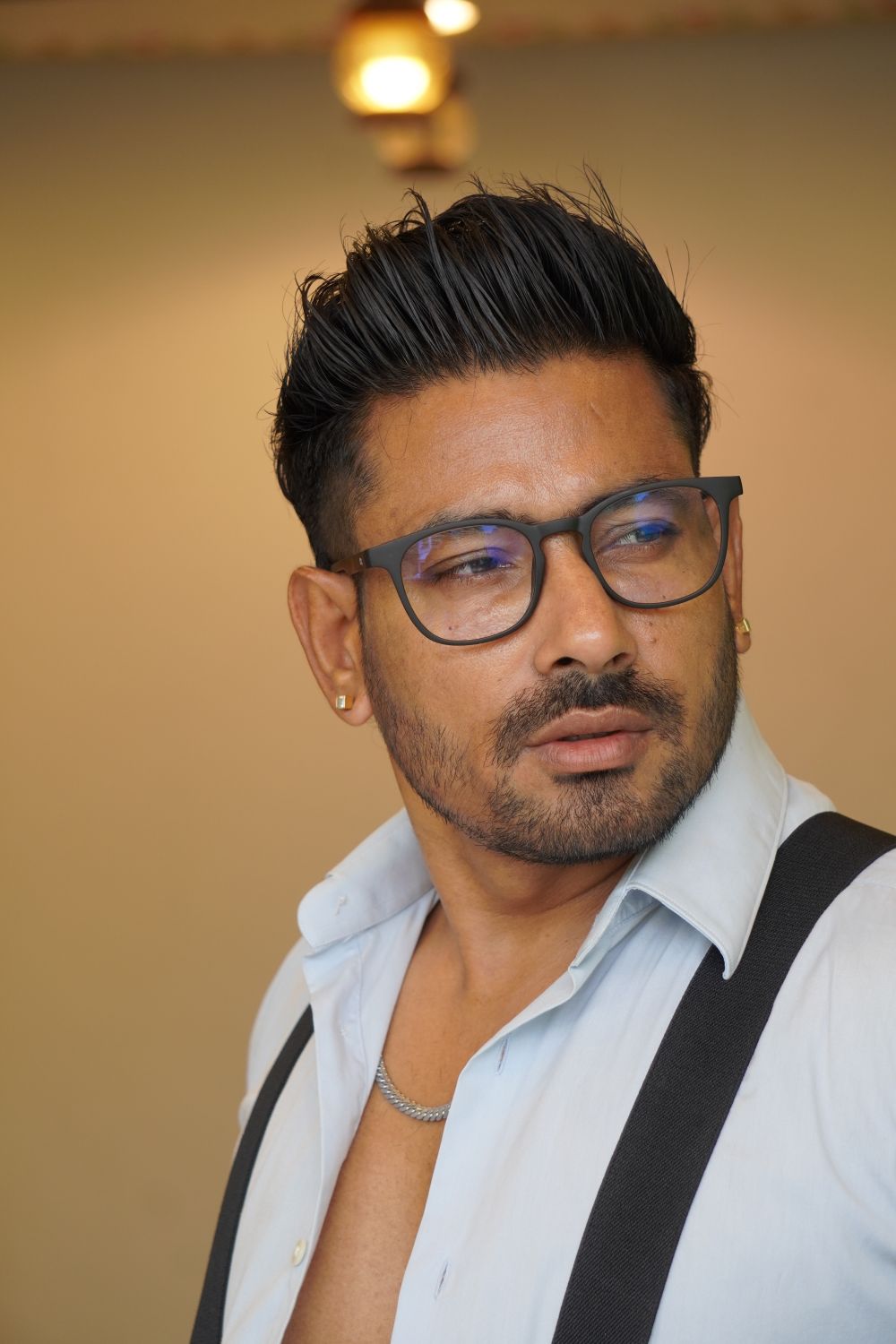man wearing glasses with a short lifted quiff hairstyle
