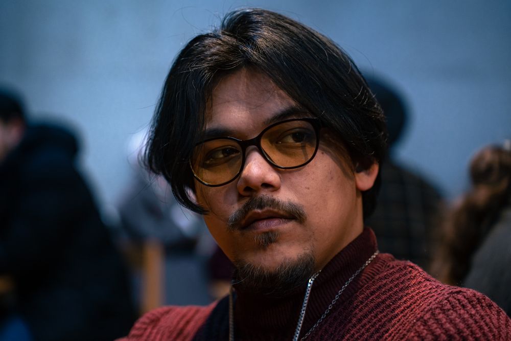 man wearing glasses with medium side swept hair