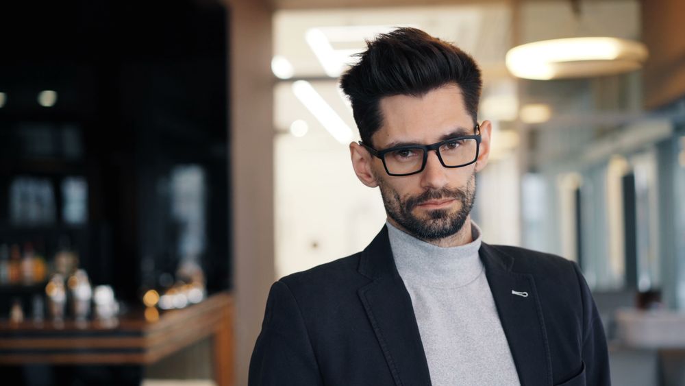 man in glasses with a polished short quiff hairstyle