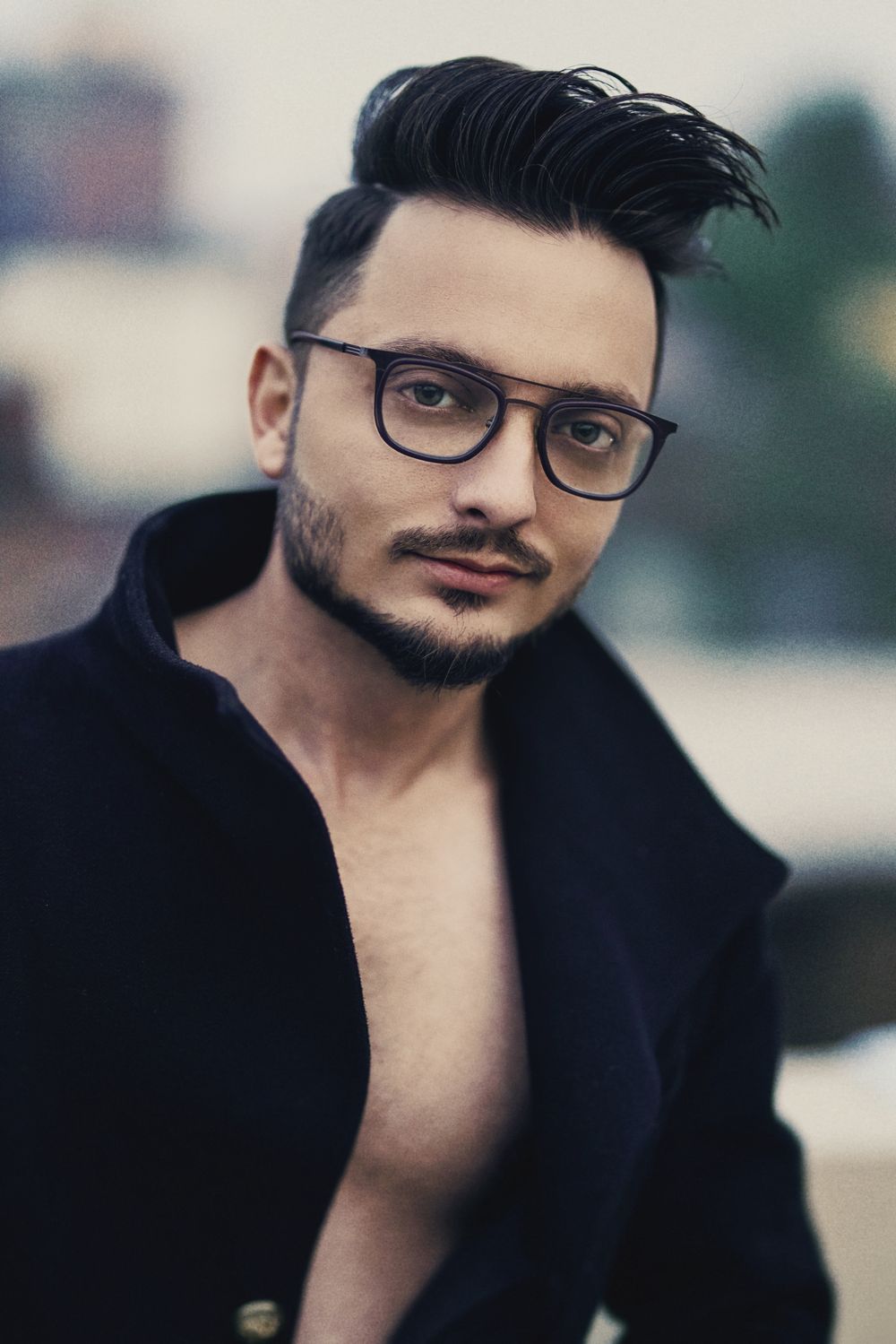 bearded man wearing glasses with short textured quiff