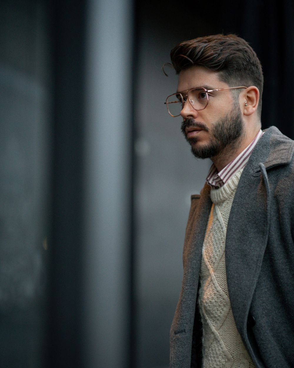 man wearing glasses with a medium side swept hairstyle