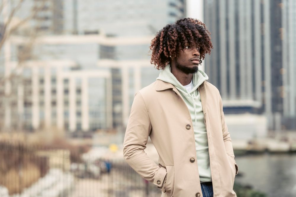 man with long curly layered hairstyle and tapered sides