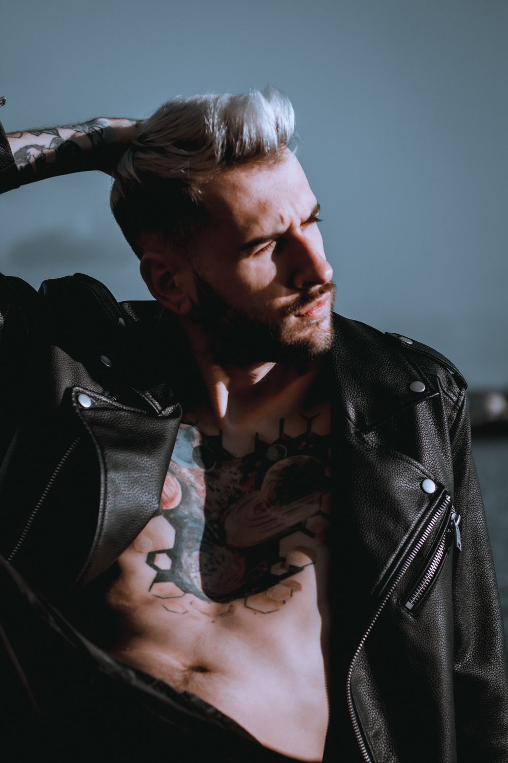 bearded man with medium wavy brushed back hair
