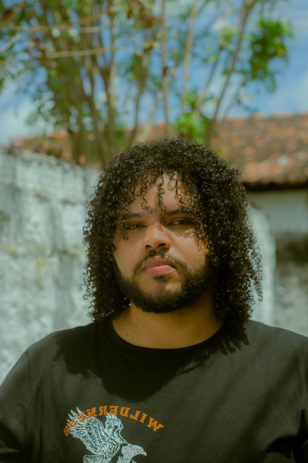 man with loose afro curls and natural medium volume