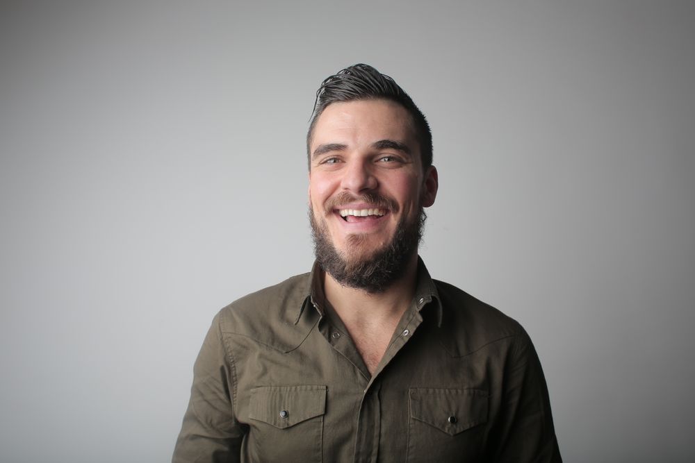man with low fade crop and shaped beard
