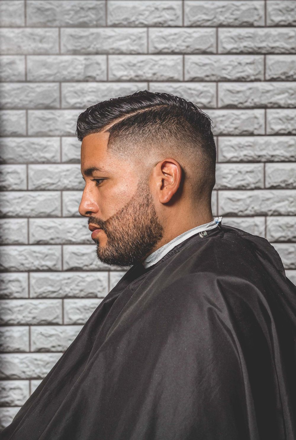 side profile of man with clean low fade and cropped top