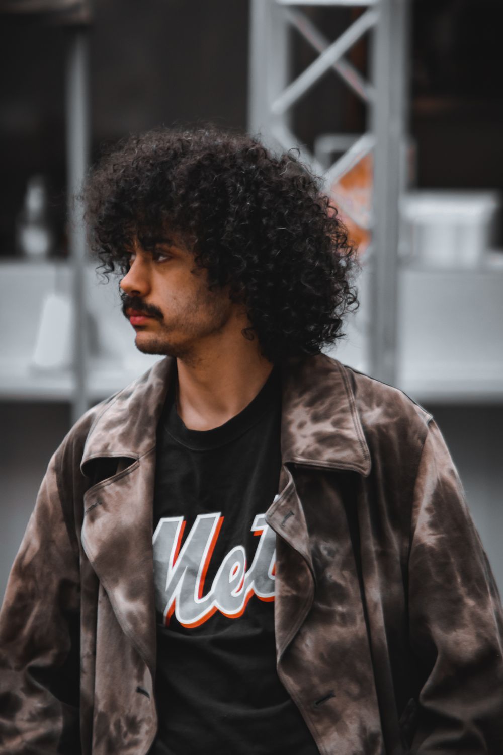 man with medium curly layered hairstyle