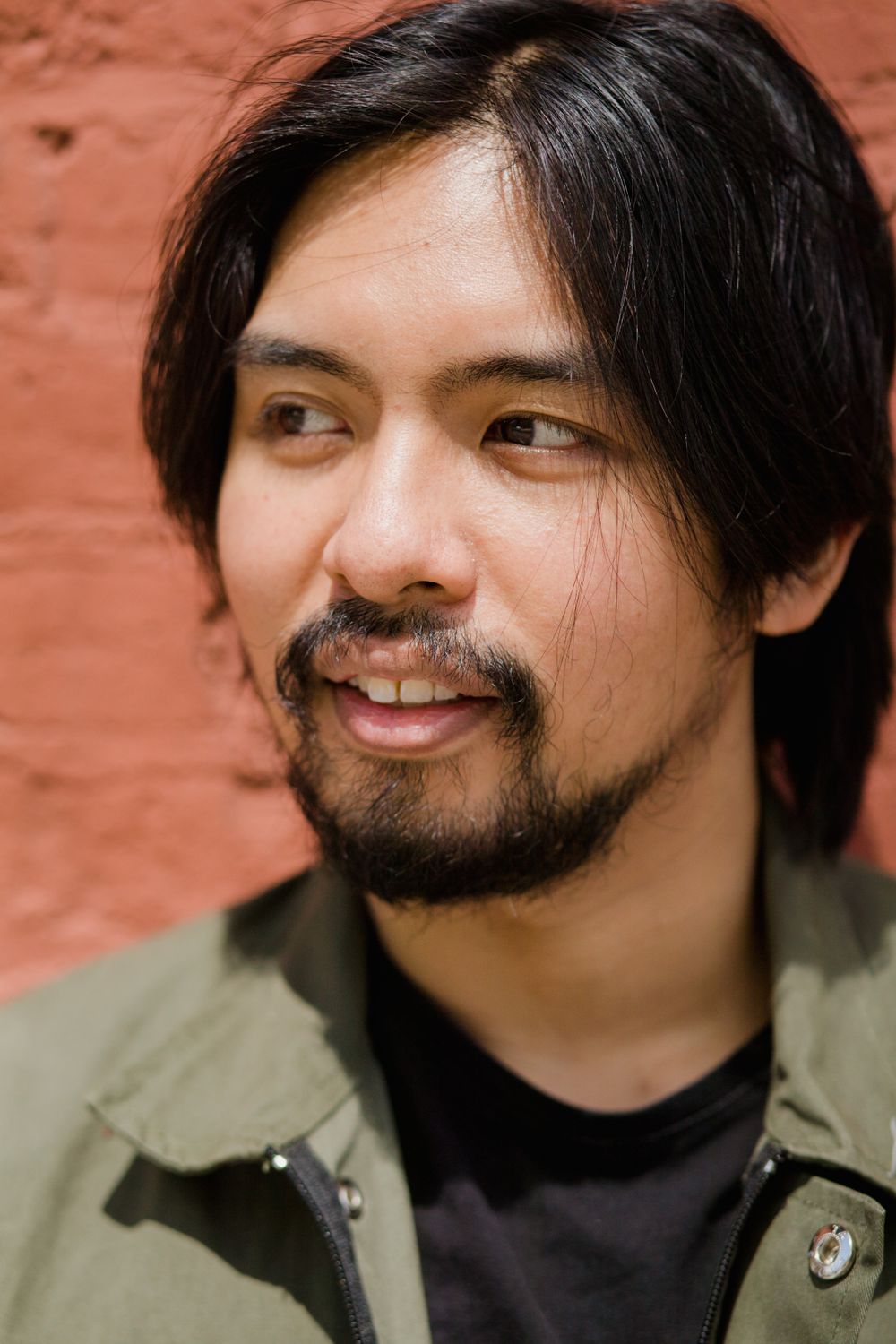 man with medium curtain style hair and a relaxed beard