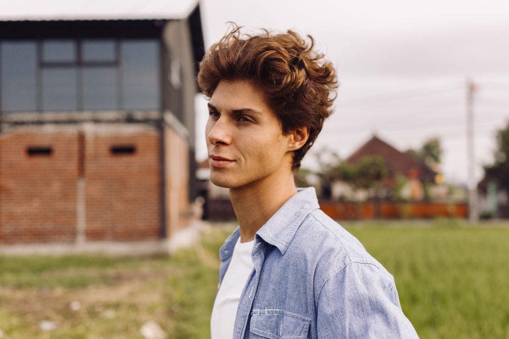 man with medium wavy hair swept softly to one side
