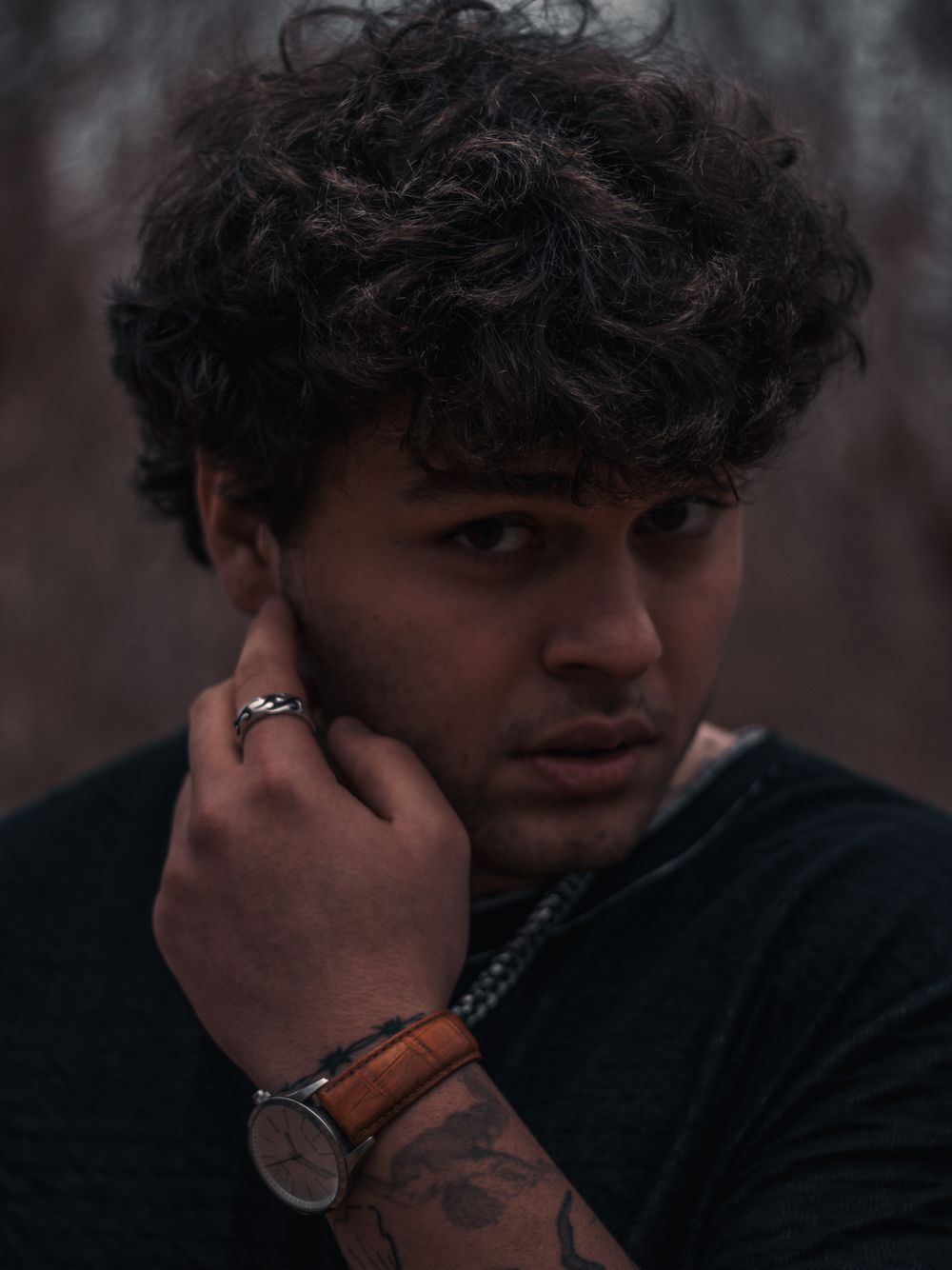man with messy curly fringe and textured medium haircut