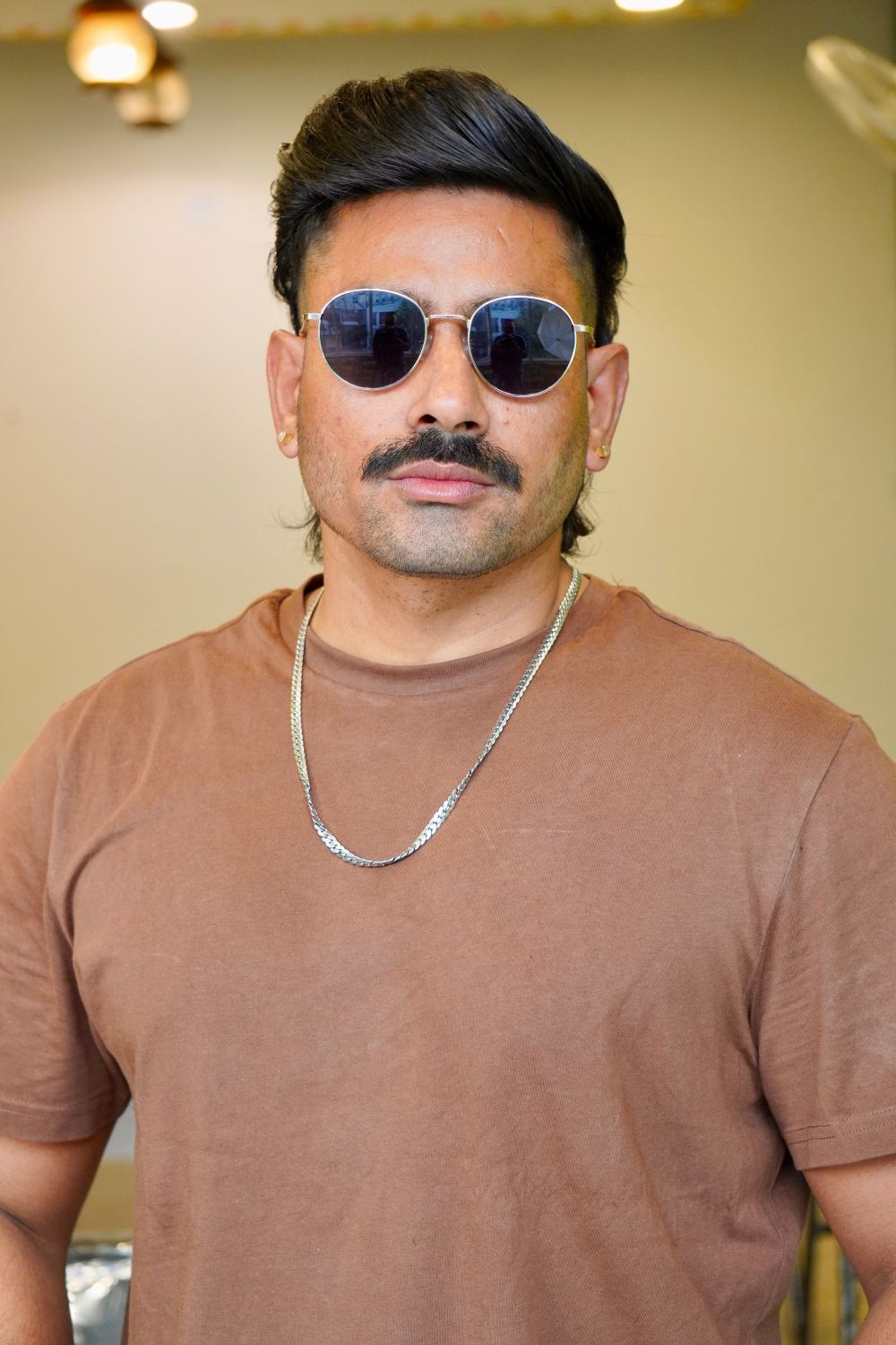 man with modern mullet hairstyle and sunglasses