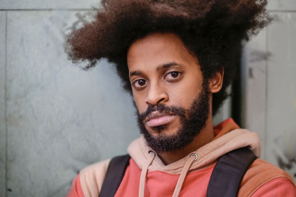 man with a natural afro hairstyle and short beard