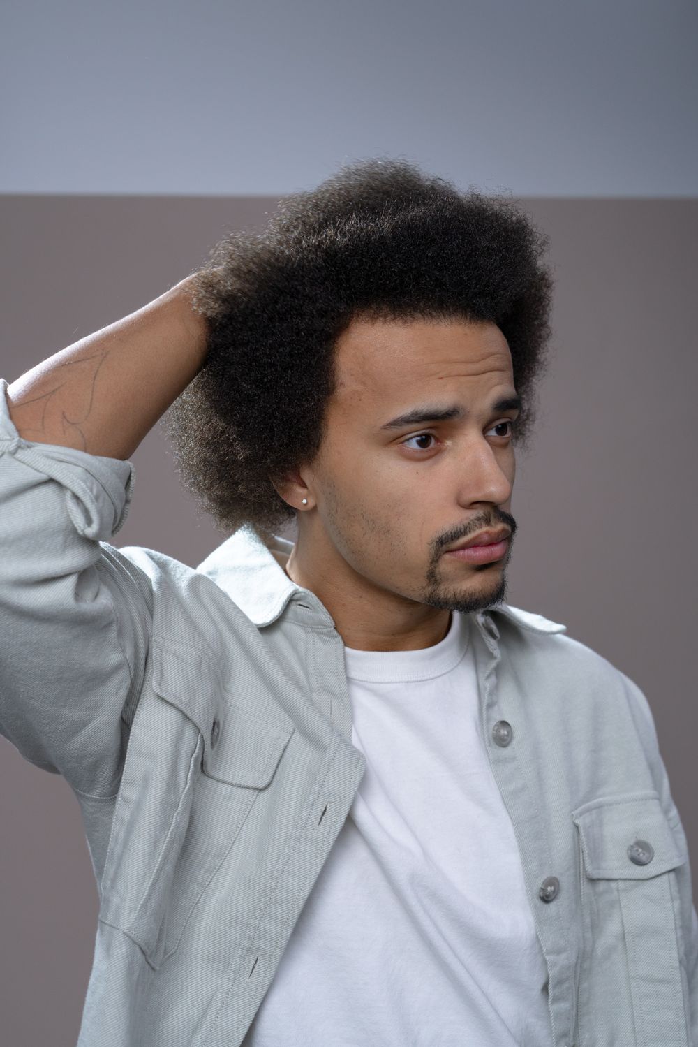man with natural afro hairstyle and soft side sweep