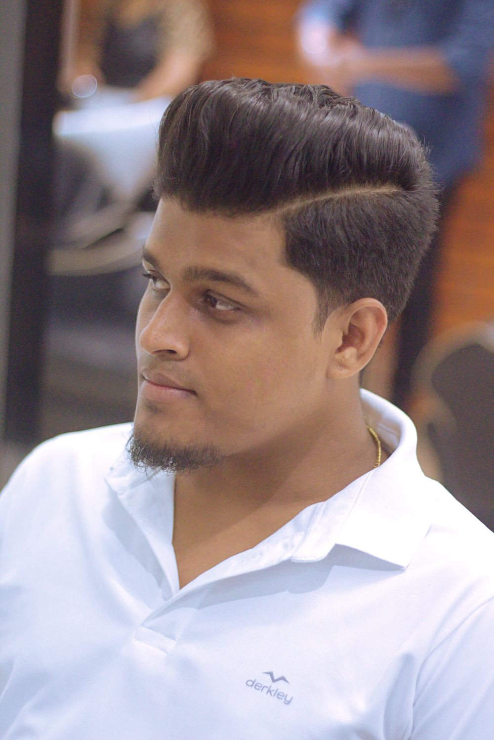 man with a polished short side part and tapered sides