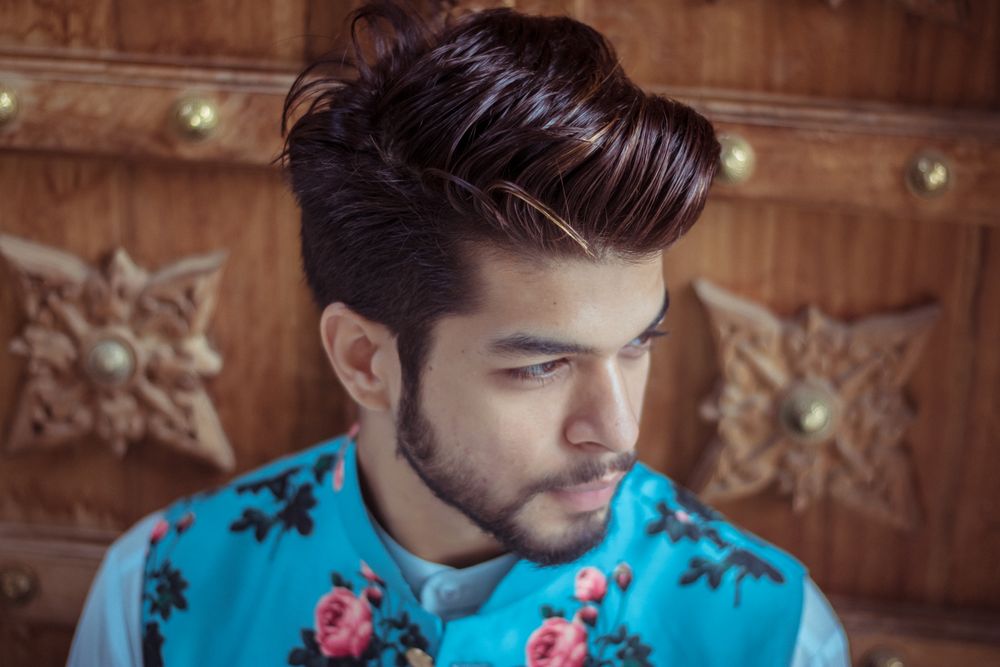 bearded man with short pompadour hairstyle and tapered sides