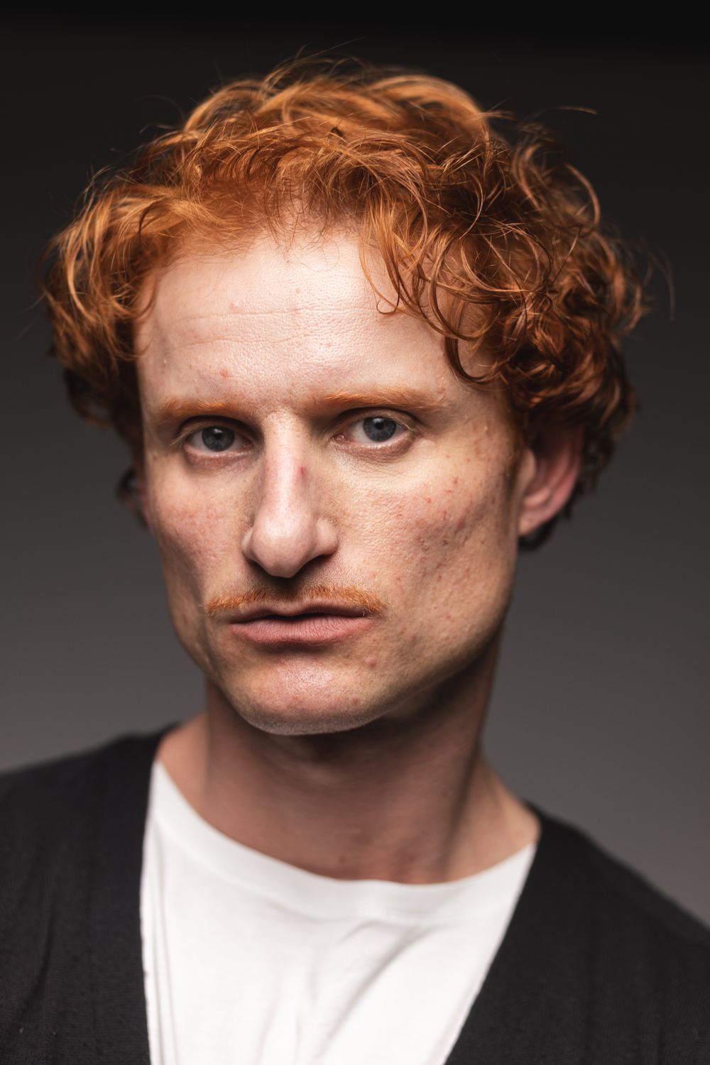 man with red curly cropped hairstyle