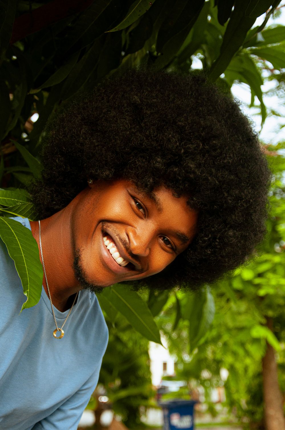 smiling man with rounded natural afro hairstyle