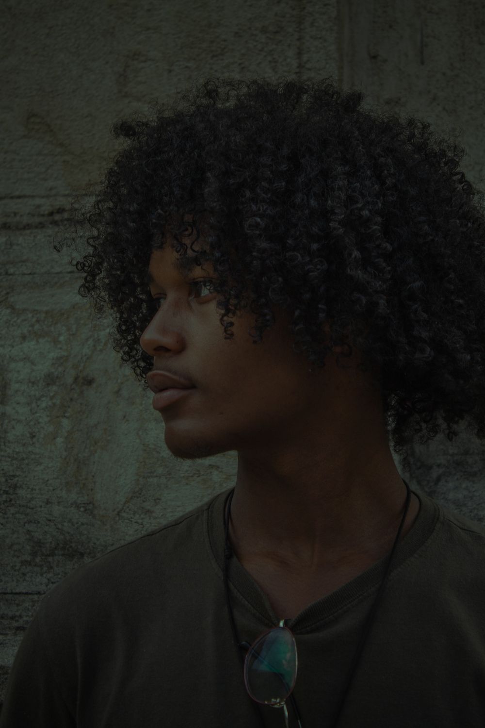 side profile of man with dense curly medium hairstyle