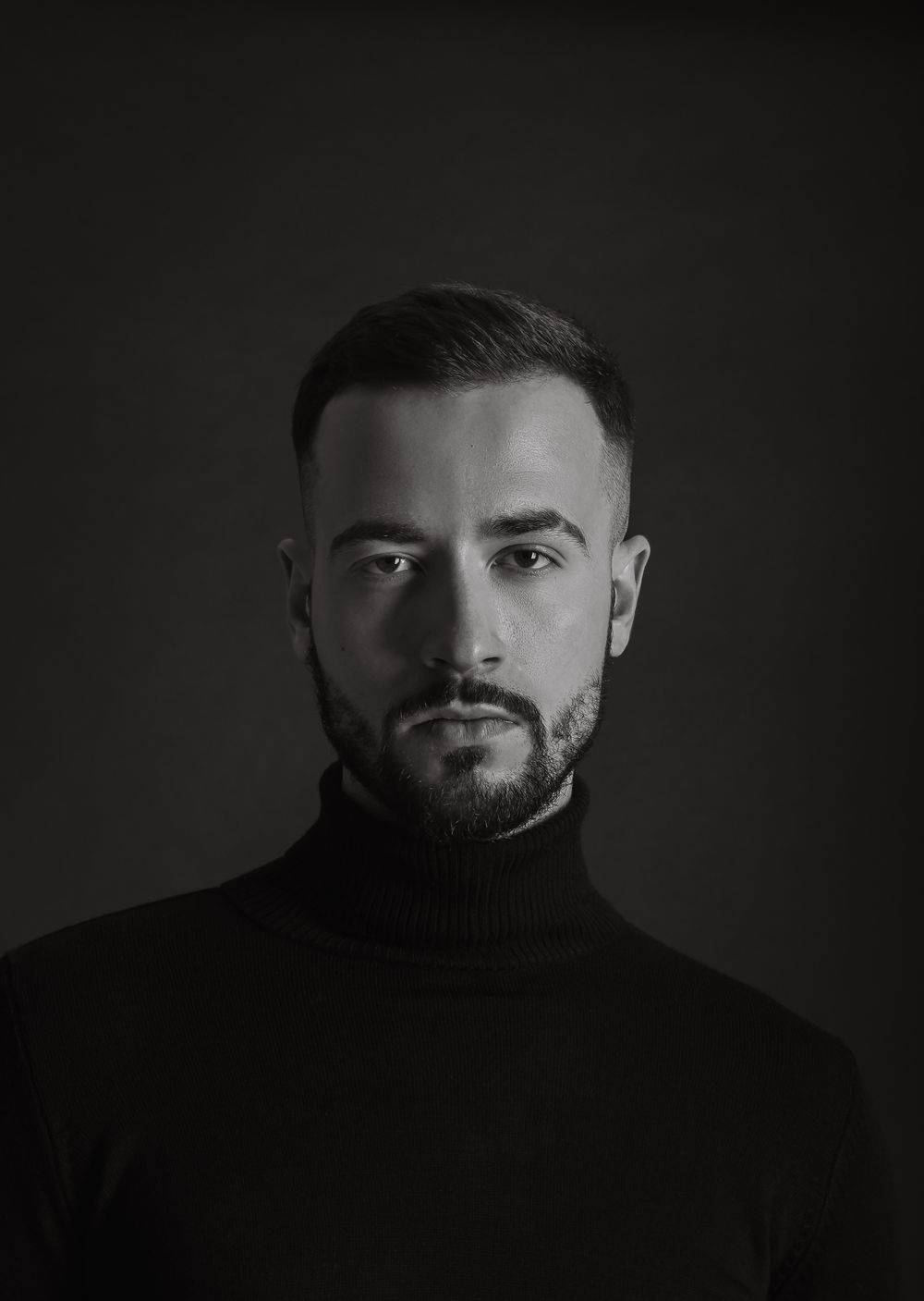 man with a short shadow fade and trimmed beard