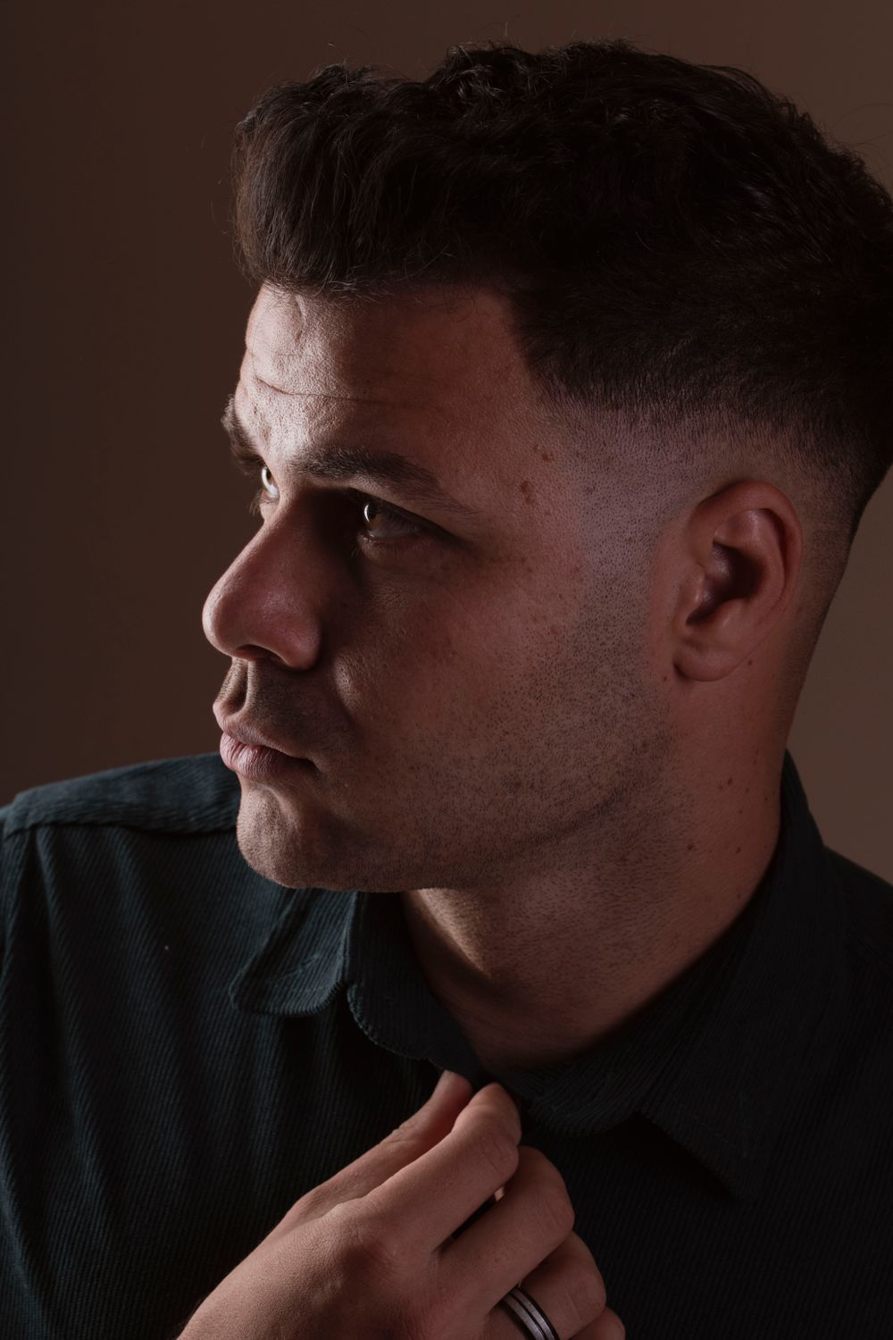 side profile of man with a close shadow low fade haircut